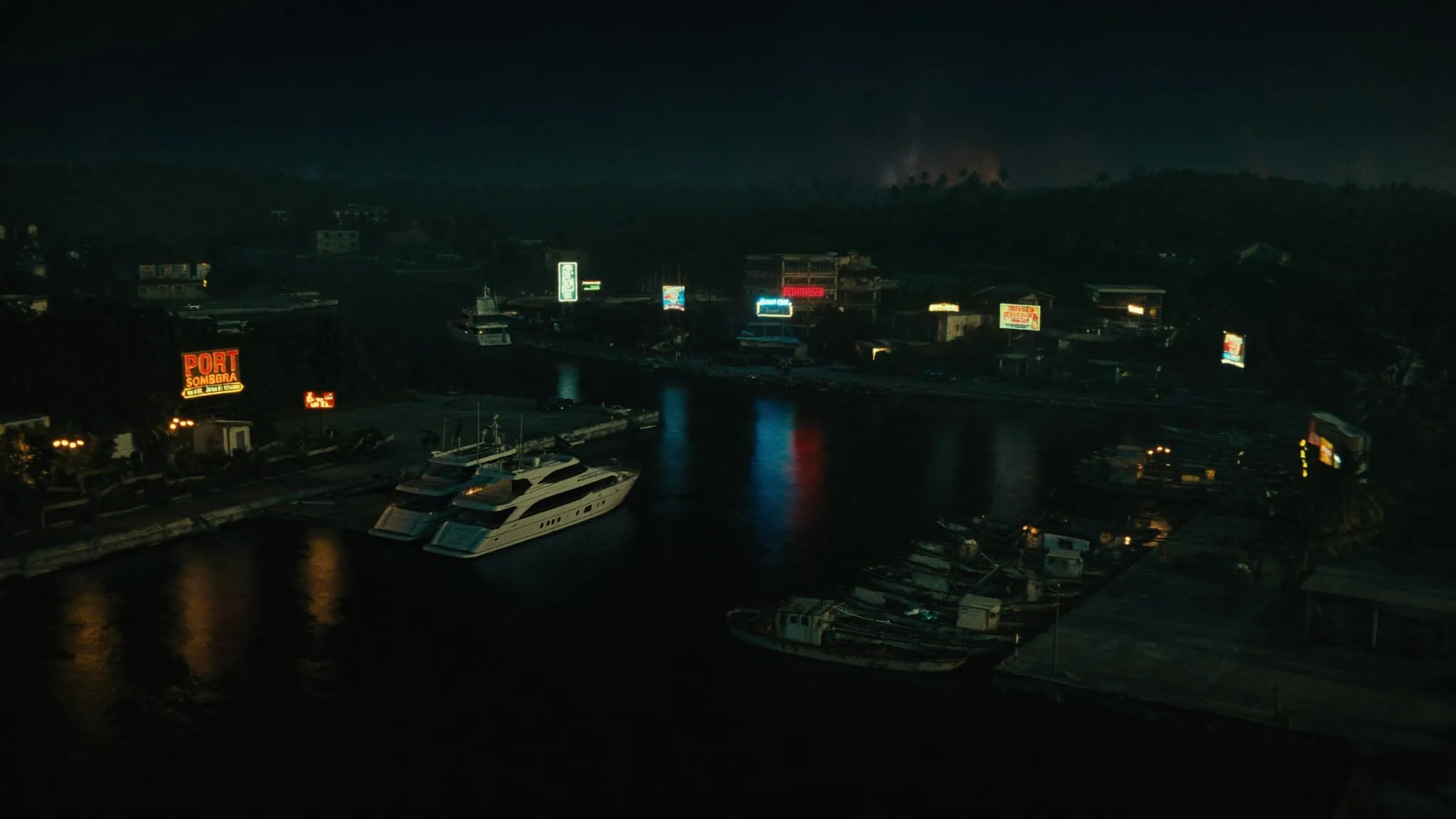 A tropical port city at night seen from the water, lit by sodium lights.